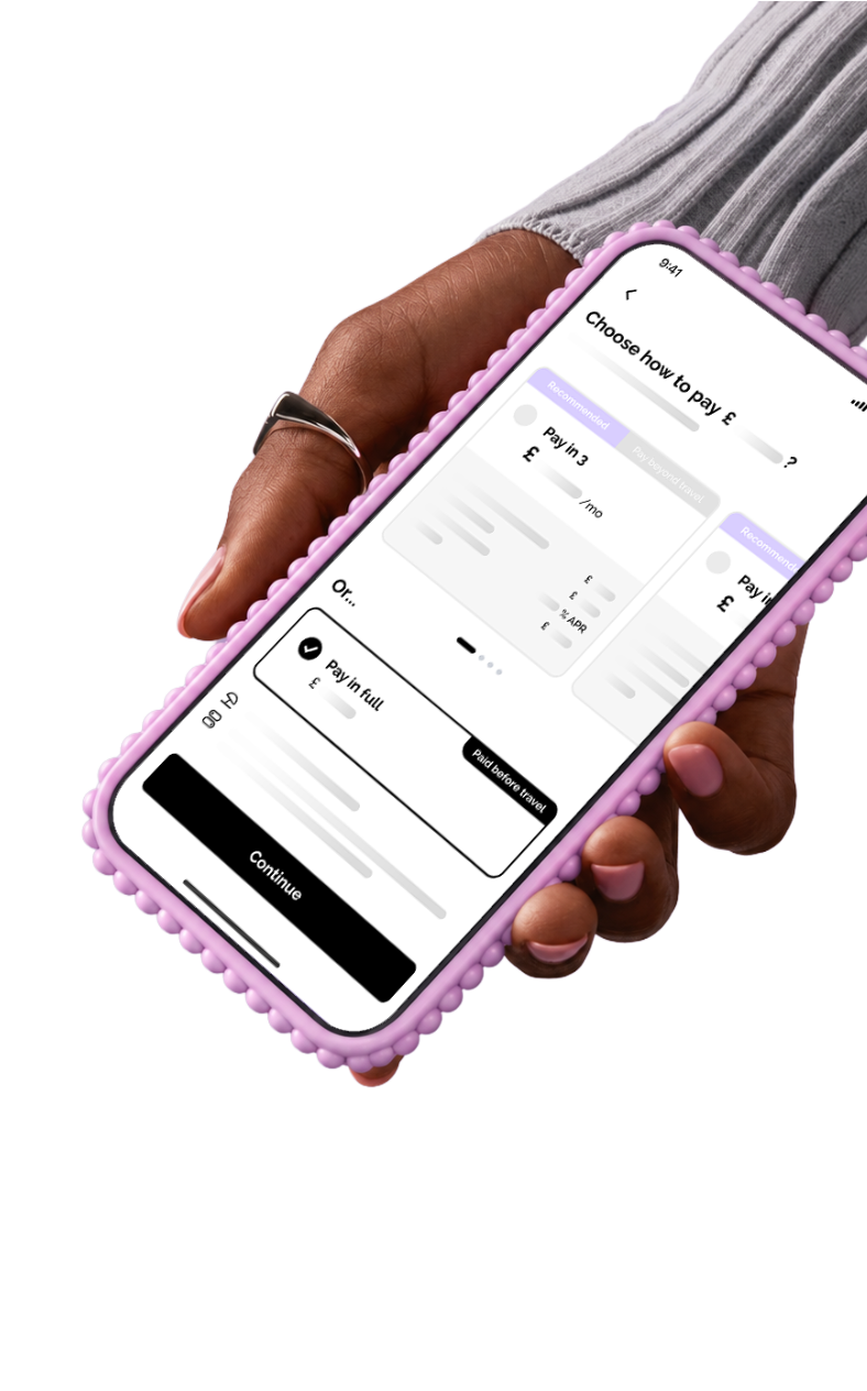 Hand holding a phone showing the Vuelo Pay in full checkout screen